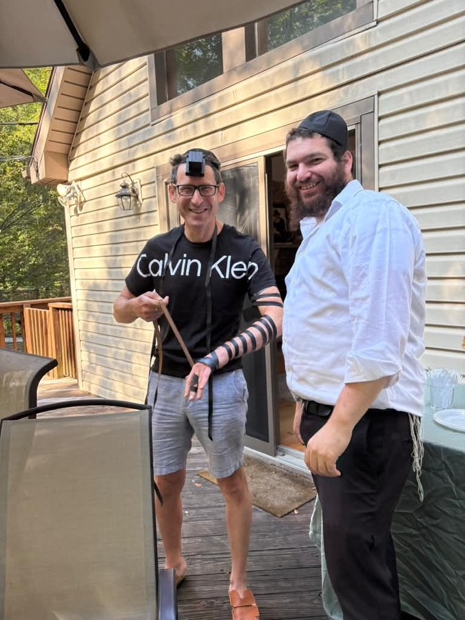 Putting on tefillin with community members